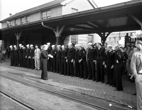 Naval reservists line up for roll call while awaiting their train to Chicago on their way to Korea.