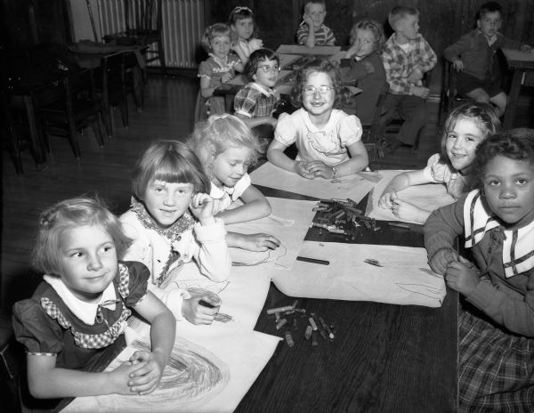 Frances Morrison's kindergarten pupils sitting at a table on their first day of school at Longfellow. They are, from left to right, Bonnie Hammersley, Sandra Faust, Jeanne Bokina, Carol Halperin, Laurel Kailin, and Mabel Smith. They were among the 11,125 pupils enrolled in Madison public schools in 1950.