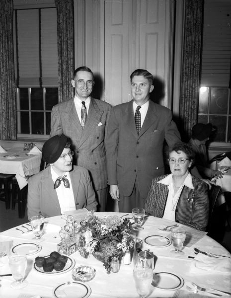 Four doctors gather in the Madison Club to arrange final details for the the third statewide Mental Health Conferance. They are left to right: Drs. Ester de Weerdt, Leslie H. Osborn, Robert G. Parkin, and Mabel G. Maston.