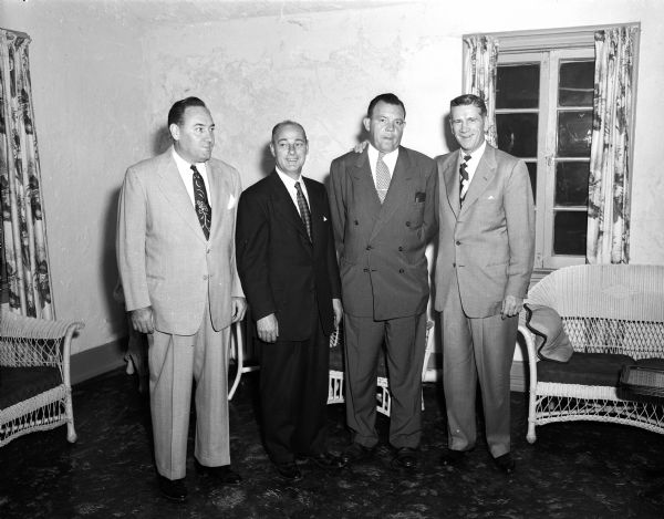 Three of "The Four Horsemen of Notre Dame" attend a farewell dinner for Harry Stuhldreher at the Maple Bluff Country Club, twenty-six years after they helped form the most famous backfield of all time. Harry Stuhldreher had been athletic director at the University of Wisconsin for more than fourteen years. Left to right are Don Miller, Harry Stuhldreher, "Chuck" Collins and Elmer Layden. Chuck Collins was an end on the team.  Jim Crowley, the fourth horseman, is not pictured.