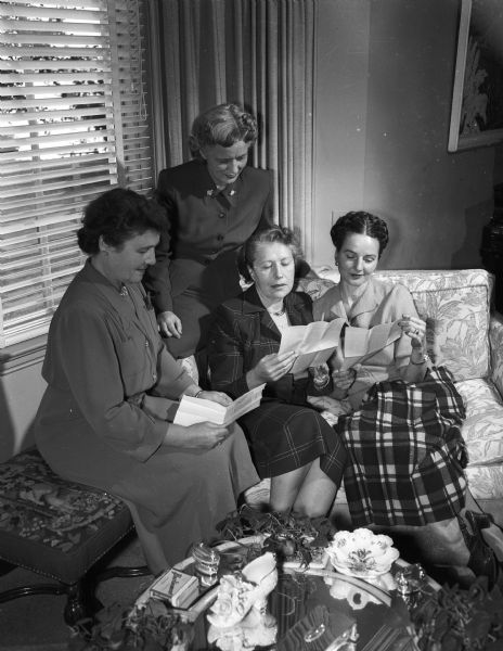 Busy with arrangements for the Silver Jubilee membership drive of the Madison Civic Music association are the board members. The photograph was taken at the home of Mrs. Adolph C. (Eugenia) Bolz, membership committee member.
Left to right: Mrs. Homer C.M.(Eleanor) Carter; Mrs. Gould (Geraldine)Morrison; Eugenia Bolz, and Mrs. George H.(Sarah) Johnson.