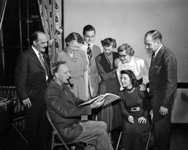 Walter Heerman discusses the score of Handel's "Messiah" with chorus members. They are Arlene Radl (sitting) and, standing left to right, Matthias Cooper, Margaret Otterson, the accompanist, Joseph Bloodgood, Mrs. Robert (Dorothy) Wellman, Jean Henriksen and George Dohms.