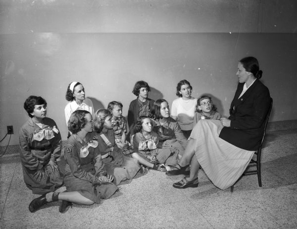 Mrs. Marianne Lohan, who is the visiting head of the "Free Movement" Girl Scouts in Germany, visits with members of Madison Girl Scout Troop 37 at Washington School. She is spending two weeks visiting with girl scouts in the Madison area as part of the Girl Scouts' Juliette Low International Friendship Fund.