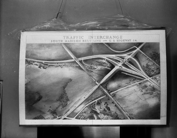 Display illustrating the Highway Department's plan for separating highway traffic on Highways 13 and 14 (the Oregon Road) and Highway 12 (the new South Madison belt line) and taking both away from the tracks of the Chicago and North Western railway.