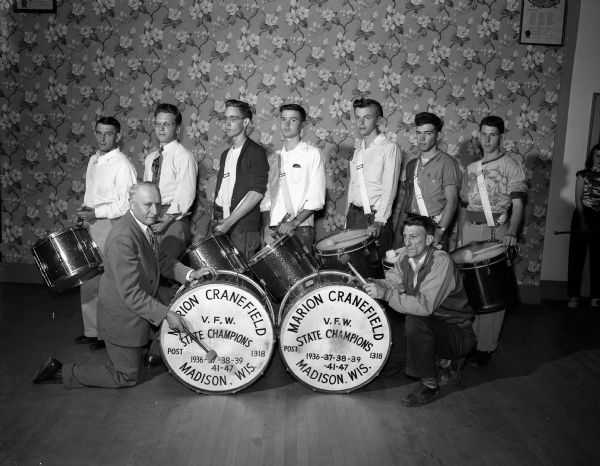 Group portrait of some of the drummers of Madison VFW Drum and Bugle Corps.  They are, back row, Bob Paul, C.R. Starr, Don Amacher, Phil Lottes, Duane Erickson, Earl Friis, and Leonard Showers; front row, Don Leicht and James MacDonald.