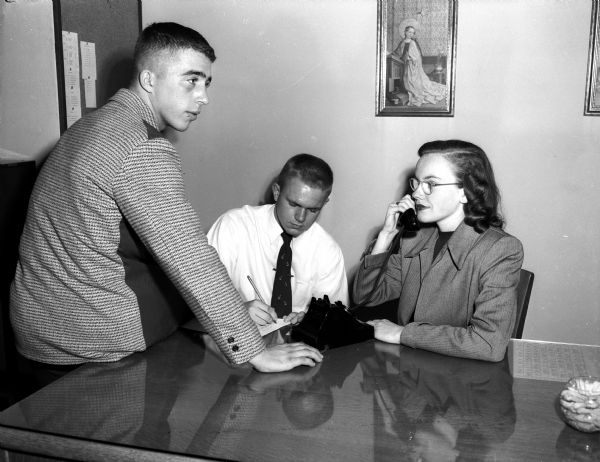 Making plans for Edgewood's homecoming dance are, left to right: Roland Spahr, senior class president; Edward Arnold, general chairman, and Marie Anthony, publicity chairman.