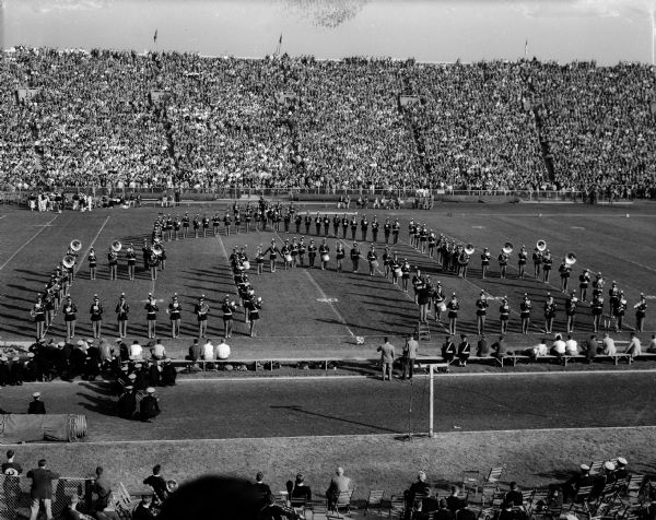 The University of Wisconsin stands in formation on the field during halftime of the Wisconsin - Northwestern football game at Camp Randall Stadium.