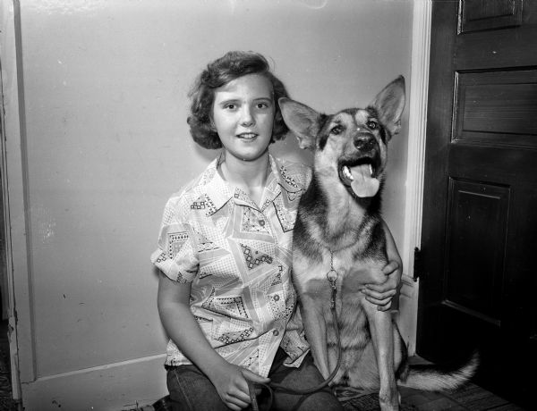 Jacqueline, 14, daughter of Phyllis Simpson of 22 South Broom Street, posing with her German Shepherd dog, Queenie.