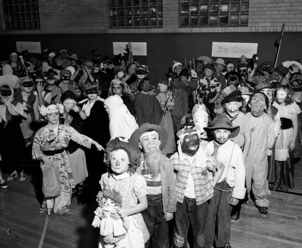At Lapham School, more than 800 costumed children and their parents attended one of the largest Halloween night parties held in Madison.  Pictured is a portion of the pupils who gathered in the school gymnasium to take part in the costume parade and games which were sponsored by the Lapham Parent-Teachers Association.