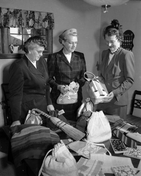 Three Pi Beta Phi alumnae are shown making arrangements for an invitational benefit and tea which will be held at the chapter house at 233 Langdon Street. Shown, left to right, are: Mrs. Russell N. (Marjorie) Colvin, general chairman; Mrs. J. Frank (Esther) Kessenich, chairman of the invitation committee; and Mrs. Theodore S. (Dorothy) Lively, president of the alumnae group.