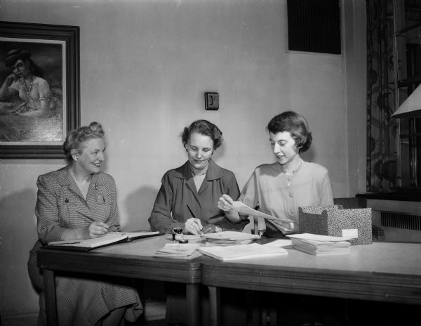Three women work on the financial drive for the University of Wisconsin YWCA. From left are: Mrs. S.M. (Helen) McElvain, a member of the finance committee; Mrs. Virgil (Helen) Herrick, chairman of the advisory board; and Mrs. E.C. Markman, executive director of the University of Wisconsin YWCA.