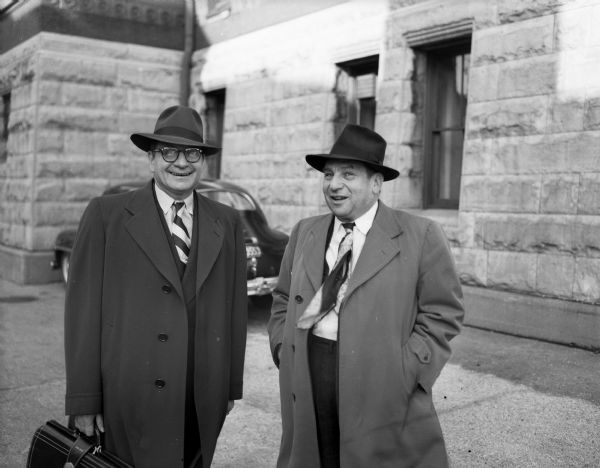 J.H. "Jake" Marachowsky, right, former president of the bankrupt Portage Wholesale Company, standing beside his attorney, Jacob Geffs, Janesville.