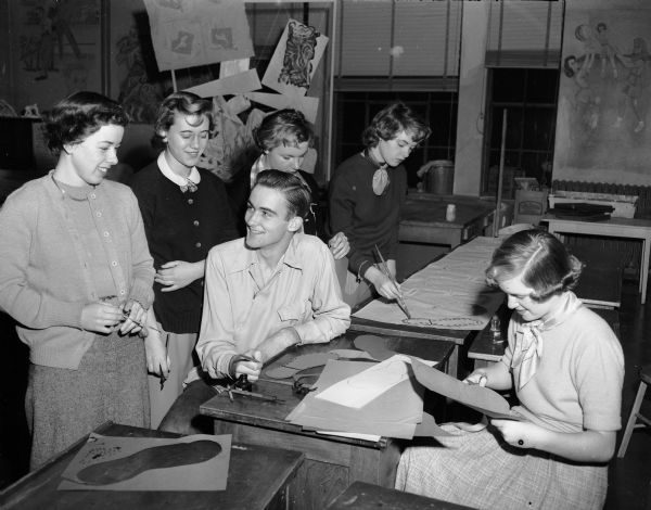Wisconsin High School students make preparations for the "Annual" dance. Standing are Jeanne Lindemann, Virginia Hammen, Cay Schramm, and Sally Carlson. Seated are Frank Tyrrell and Nancy Schneiders.