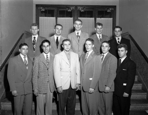 Madison all-city football team poses for a group portrait at the annual banquet sponsored by the Madison Shrine Club. In the first row, left to right, are: John Bieberstein, Central; Jim Namio, West; Glenn "Jack" Barry, West; Jim Kurth, East; Jim Clapp, West; and Eugene Eldred, East. In the second row, left to right, are: Dale Pollock, East; Harold Mathison, West; Leo Schlicht, East; Ken Verley, East; and Gary Messner, East.