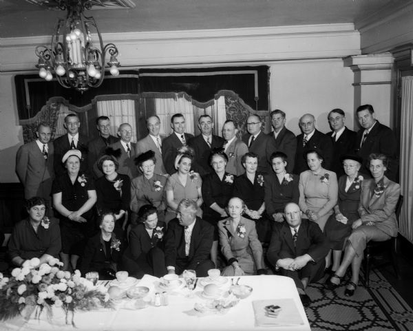 Group portrait of the members of the Quarter Century Club of the Kennedy-Mansfield division of Borden's. They were honored at the company's party at the Hotel Loraine.