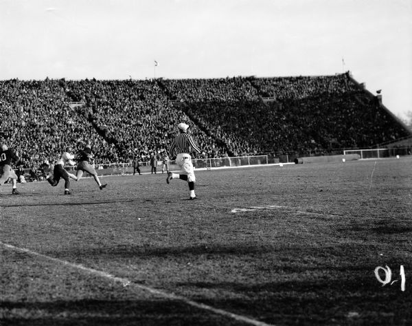 Kerm Klefsaas, Minnesota, carries the football across the field before he is tackled by Jim Hammond, Wisconsin. Final score: Wisconsin 14; Minnesota 0.
