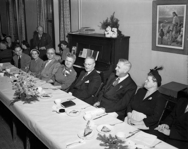 Scene at a dinner for Bishop H. Clifford Northcott, head of the Wisconsin area of the Methodist Church, at First University Methodist Church. Seated at the speakers table are, left to right: Rev. Allen McCaul, associate pastor; Mrs. Justus (Gertrude) Olson. John Wrage, church board president; Mrs. Northcott; W.M. Harris, toastmaster; Bishop Northcott, and Mrs. Merrill R. Abbey, wife of the pastor of First University Church. Bishop Northcott was reporting on a recent trip to Africa and Europe.