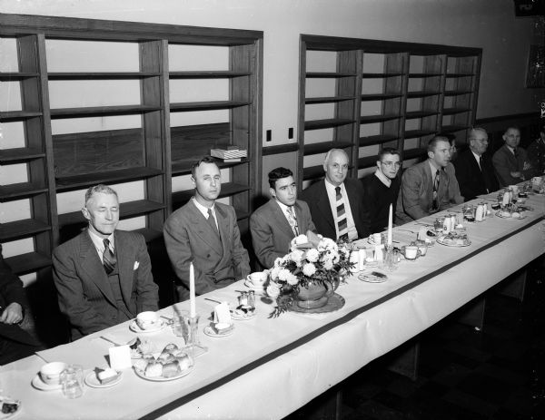 The speakers at the annual West High School football dinner, seated at the head table from left to right. They are: R.O. Christofferson, West High principal; Roland Sergenian, toastmaster; Willis Jones, football coach; and team co-captains, Glenn "Jack" Barry and Robert "Red" Wilson.