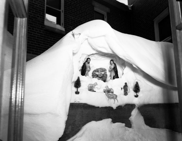 Nativity figurines are placed in a naturally formed snow cave outside a courtyard window of the St. Mary's Hospital kitchen.