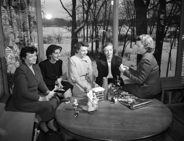 The planning committee for the annual Christmas dinner dance of the Naval Officers' and Wives club includes, left to right: Mrs. R.R. (Gladys) Gehrand, Mrs. John (Lulu) Mailen, Mrs. R.L. (Maxine) Kulzick (general chairman), Mrs. Joseph (Kathryn ) Sutton, and Mrs. Stuart (Helena) Wright.