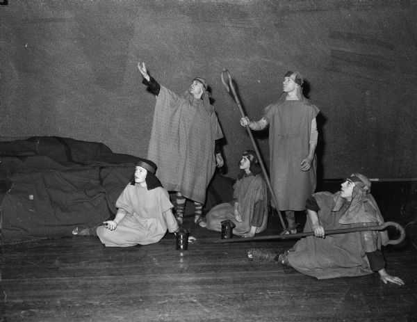 Five Edgewood High School seniors are shown acting on stage costumed as Nativity shepherds. They are (left to right) Roland Spahr, Victor Crapp, Betty Bollig, Earl Ross, and Dorothy Lacey.