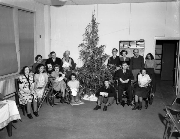 A group of severely handicapped adults who take part in the homecraft program of the State Board of Vocational and Adult Education Rehabilitation Division are shown at a Christmas Party sponsored by the Madison Altrusa Club.