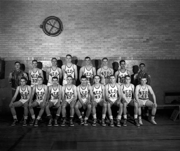 Group portrait of 15 players and 2 managers of the undefeated Madison West High School basketball team.