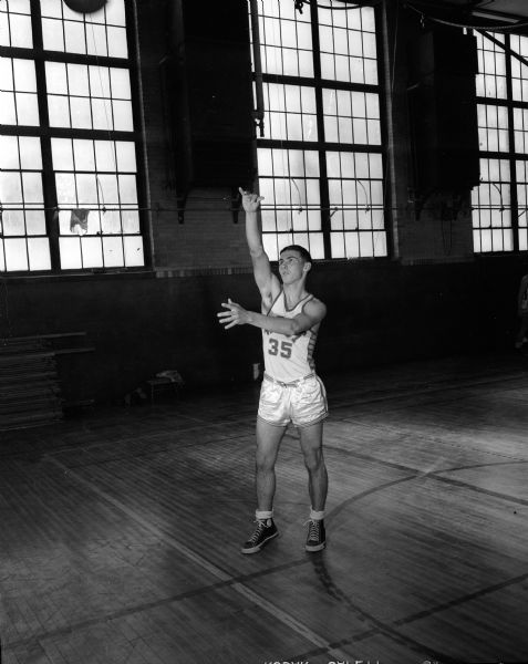 Billy Marshall, a guard and one of Madison West High School basketball team's three leading scorers, shoots on the court.
