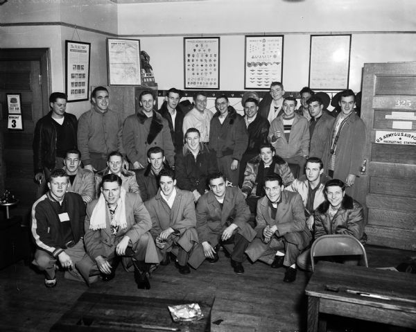 A group of air force enlistees poses for a group portrait before departing from Madison for Milwaukee. They are part of the thirty-three who were accepted at the Madison recruiting station in the Federal building.