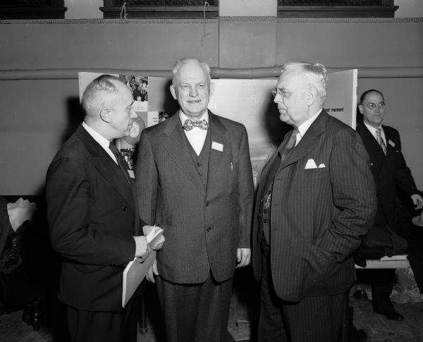 Three participants in the Wisconsin Council of Churches converse at the group's annual dinner. Pictured from left to right are: Rev. William D.F. Hayes, Madison Congregational minister and new vice-president of the state council; J.H. Hoff, Waukesha Baptist, new council president; and Bishop Ivan Lee Holt, St. Louis Methodist council of bishops, main speaker at the dinner.