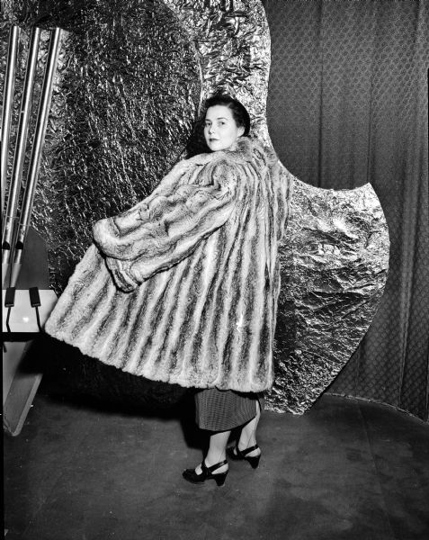 The only "let-out" coat made of matched chinchilla fur in existence is modeled by an unidentified woman at a Milwaukee style show.