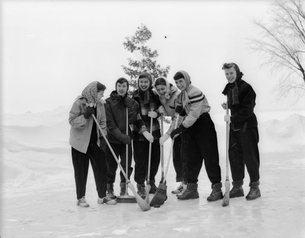 Members of the Kappa Gamma sorority team on the University of Wisconsin-Madison campus are pictured practicing for the broom hockey matches to be held as part of the Wisconsin Hoofers Winter Carnival.