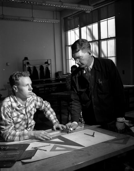 Drafting student Bruce Maxwell confers with his instructor, Herbert Zimdars.  They are participating in Central High School's first year of Trade and Technical Courses.