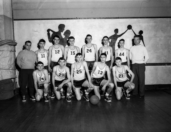 Group portrait of the uniformed Monticello High School boys' basketball team with their coaches.