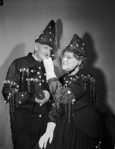 Henry Naumann and Mrs. Julia Bennett pose for a portrait while wearing costumes at the Older Adult Klub masquerade ball. The event was held at the Madison Community Center.