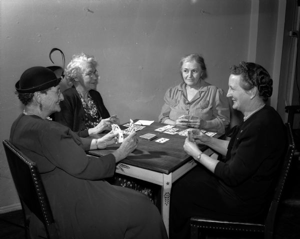 Members of the Older Adult Klub play canasta at the Madison Community Center. They are Mrs. Minnie Ewing, Mrs. Carrie Soule, Mrs. Margaret Durkee, and Mrs. Louise Harvey.