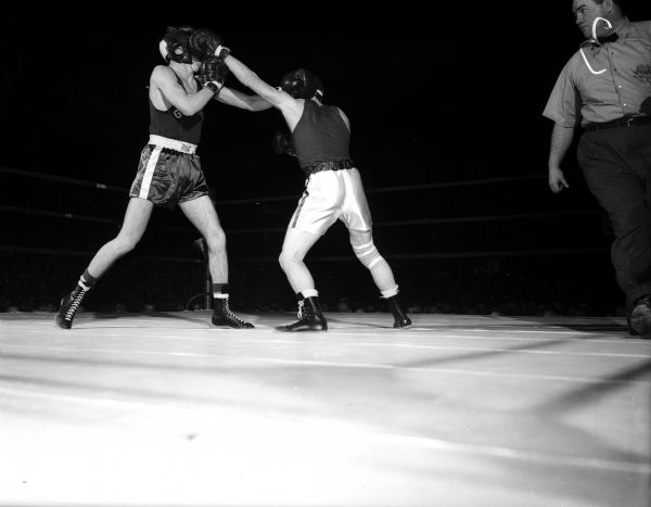 Two boxers, Gonzaga University's Gordon Simanton (left) and University of Wisconsin's Gene Diamond, both miss punches in the first bout of the Gonzaga-Wisconsin boxing team matches.