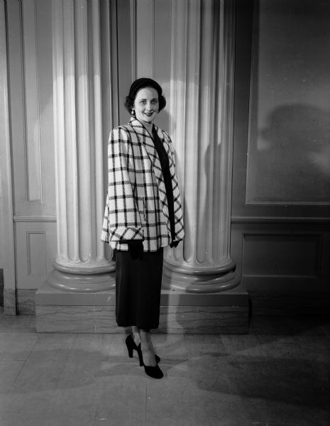 Jane Montgomery modeling a dress with a long jacket for the Jaycette fashion show.