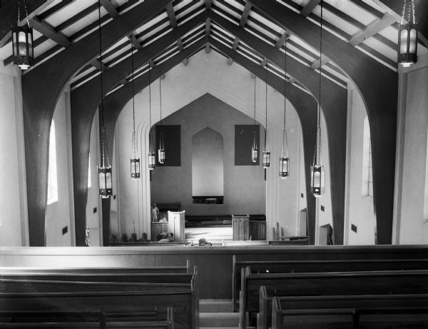 Interior view of the new First Baptist Church located at 518 North Franklin Avenue, showing the sanctuary with laminated wood beams and Gothic proportions.