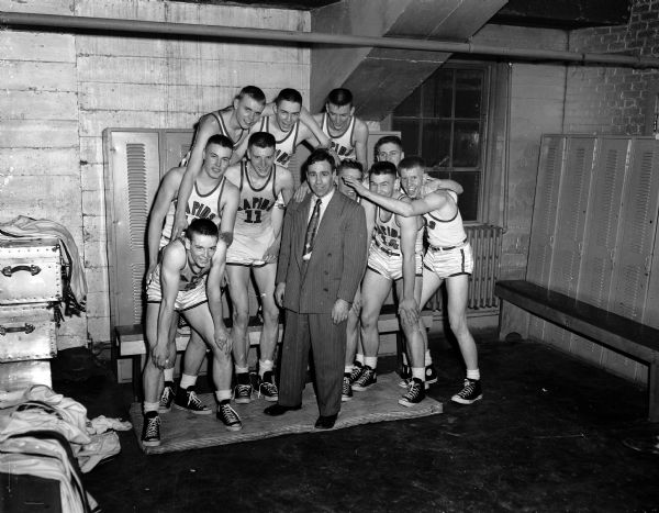 The Wisconsin Rapids High School basketball team gathers around their coach, Phil Manders, after winning the championship of the state boys basketball tournament at the University of Wisconsin-Madison Field House.