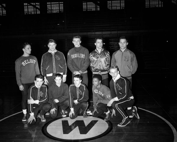 Individual winners of the state high school wrestling tournament pose on a mat in the University of Wisconsin-Madison Field House.