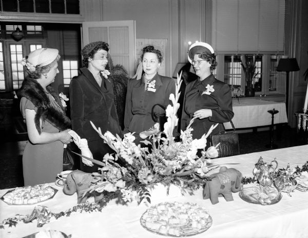 Wives of Republican elected officials were guests of honor at a tea held at the Madison Club, located at 5 East Wilson Street. Shown at the tea table are, from left: Mrs. Warren R. (Dena) Smith, wife of the state treasurer; Mrs. Walter J. (Charlotte) Kohler, Jr., wife of the governor; Mrs. Vernon (Helen) Thomson, wife of the attorney general and Mrs. George M. Smith, wife of the Lieutenant governor, Milwaukee, Wisconsin.
