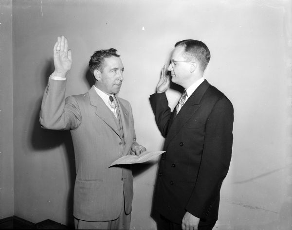 Thomas Fairchild, right, former Wisconsin Attorney General, is sworn in as United States Attorney for the Western Wisconsin District. D.M. Alsad, Clerk of Court, gives the oath.