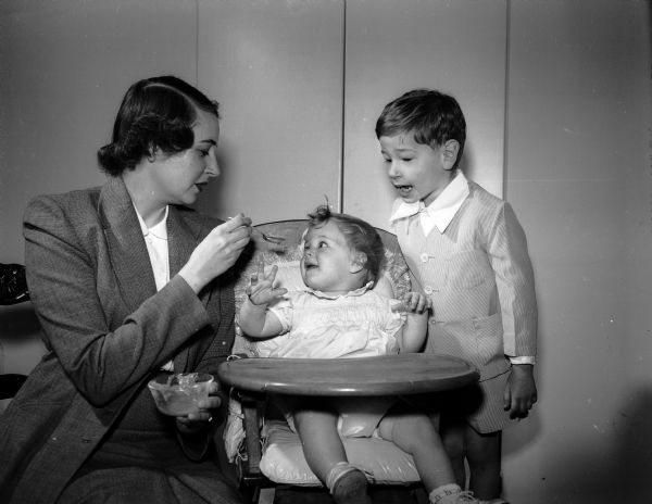 Mrs. Ernest F. (Babette) Rice is shown with her daughter, Kathy, 10 months, and her son, Johnny, 3 1/2 years old, in their apartment at Sherman Terrace where many of the new Air Force families live. Her husband Captain Ernest F. Rice is with the 128th Fighter Wing at Truax Field.