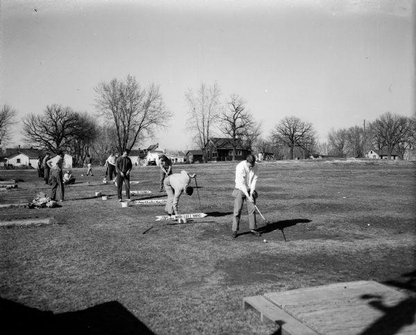 Men using the driving range at the Fairway Golf Range, located at 2211 South Park Street across from the Burr Oaks golf course.