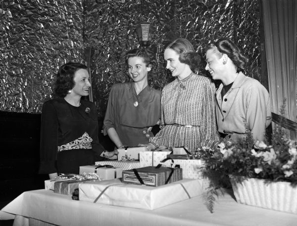 Members of the arrangements committee for the Who's New Club annual spring dance to be held at the Club Chanticleer. From left are: Marie Shrout, Mrs. Vern Heim, Mrs. Lewis Johnson, and Norma Krueger.