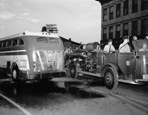 A Madison fire truck parks at the scene of a Greyhound bus fire at the corner of East Main Street and South Pinckney Street in front of the S.S. Kresge store.