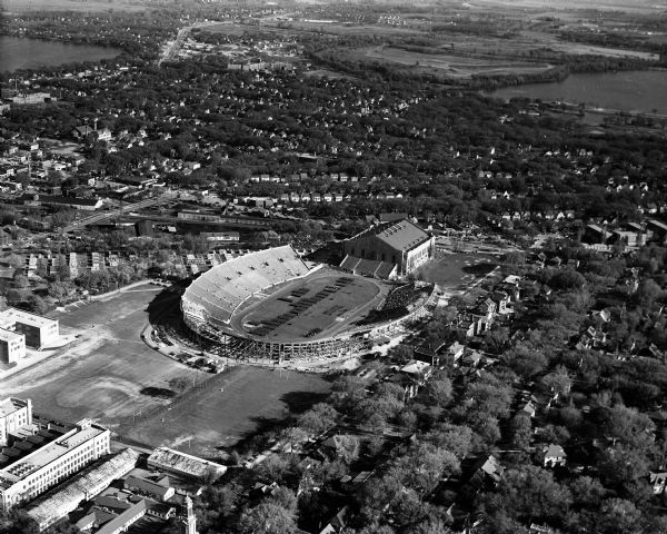Aerial view of Camp Randall Stadium and Fieldhouse looking south. The photograph was taken during a ROTC annual inspection.