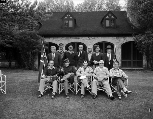 Twelve Norwegion men observe the opening of Madison's observance of Syttende Mai, the Norwegion Independence Day, with a "golfspill" at the Nakoma Golf Club. In the front row (left to right) are Lester Lee, Olaf Strand, Truman Thompson, Ned Nedrebo, and Dr. Donald G. Toraason. In the back row (left to right) are Basil I. Peterson, Herman Loftsgordon, Julian Johnson, Gerhard Naeseth, Oscar Christianson, Arthur Lowe, and Alf Kjerverud.