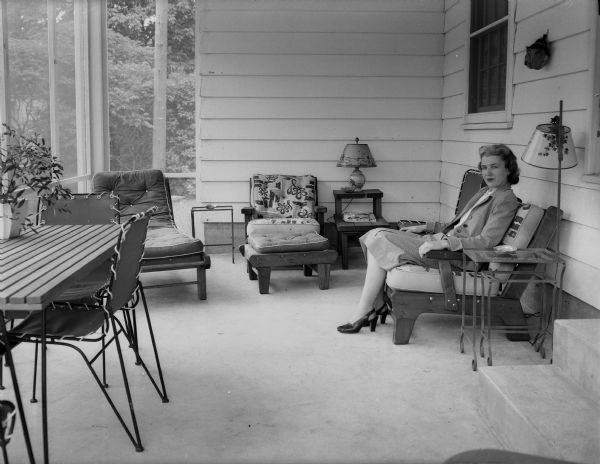 Mrs. Fred (Eleanor) Griffith sitting on the screened porch of her home at 4204 Hillcrest Drive.